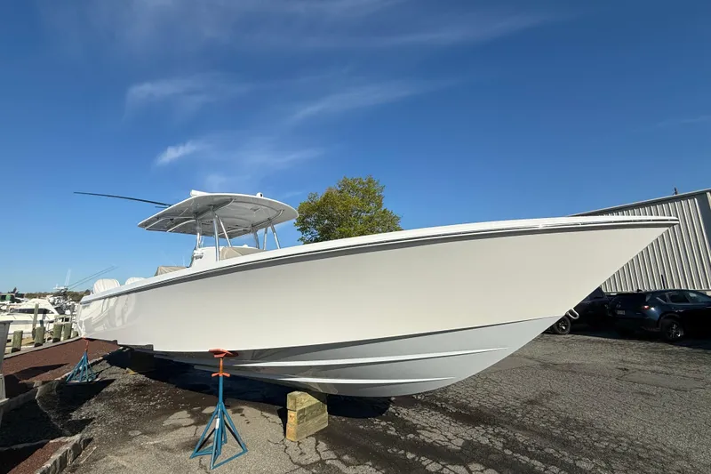 The Image of 2026 Contender 39 ST boat on stands under clear blue sky. - 0