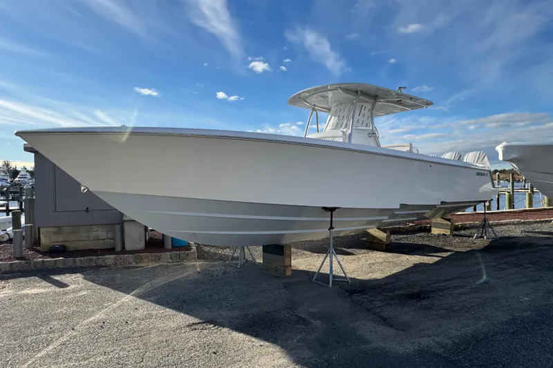 The Image of 2026 Contender 39 ST boat on display at a marina under a clear blue sky. - 1