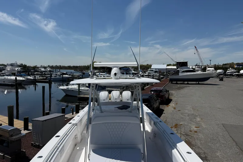 Slide: The Image of 2026 Contender 39 ST boat docked at a marina with other vessels. - 11