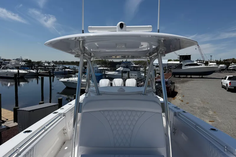 Slide: The Image of 2026 Contender 39 ST boat docked at marina under clear blue sky. - 14