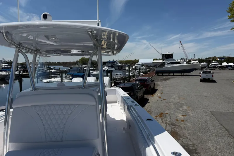 Slide: The Image of 2026 Contender 39 ST boat docked at marina with clear blue sky. - 18