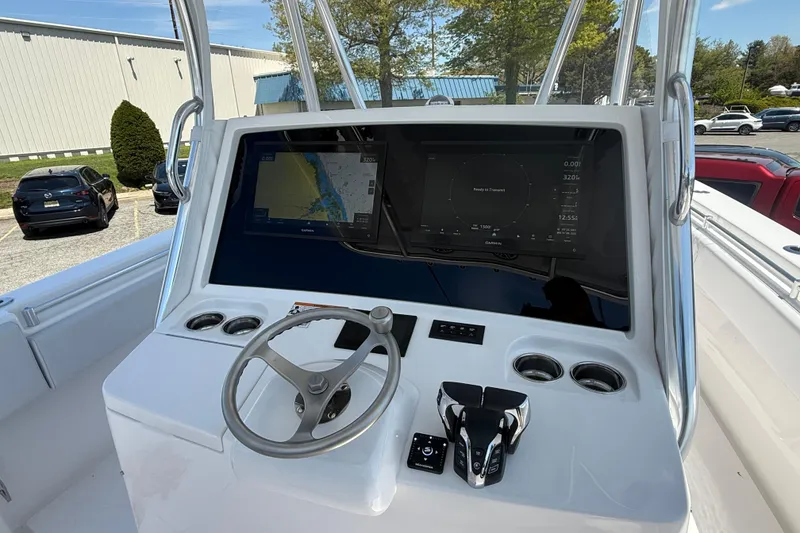 Slide: The Image of 2026 Contender 39 ST boat helm with navigation screens and steering wheel. - 20