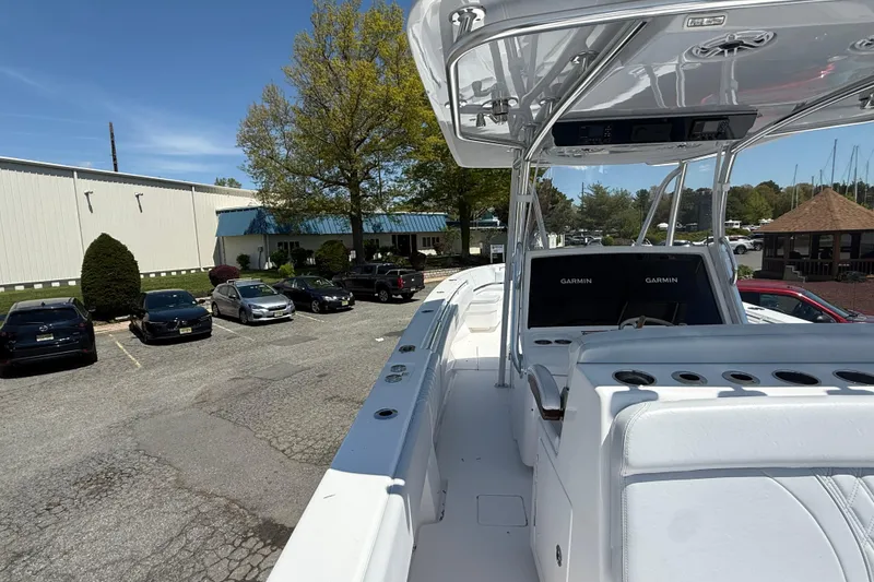 Slide: The Image of 2026 Contender 39 ST boat with Garmin displays, parked near a building and cars. - 25