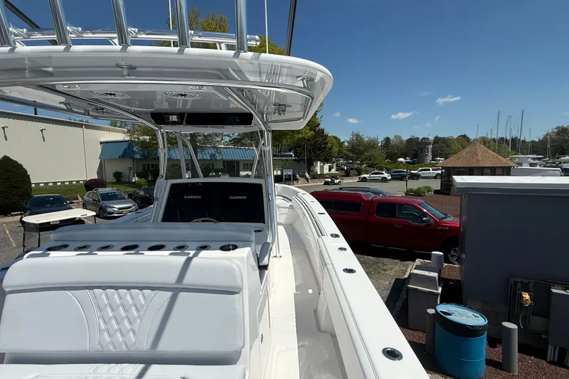 Slide: The Image of 2026 Contender 39 ST boat with dual Garmin displays, docked under clear blue sky. - 26