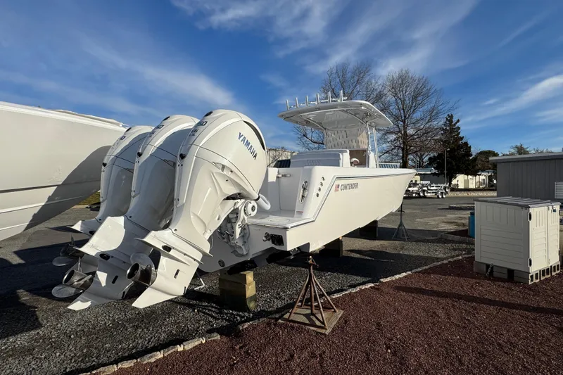 Slide: The Image of 2026 Contender 39 ST boat with Yamaha engines on display outdoors. - 4