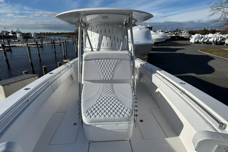 Slide: The Image of 2026 Contender 39 ST boat with sleek seating and modern design at a marina. - 8