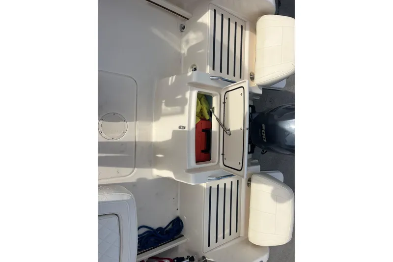 Slide: The Image of 2018 Grady-White Freedom 215 boat interior with storage compartment and Yamaha 200 engine. - 12