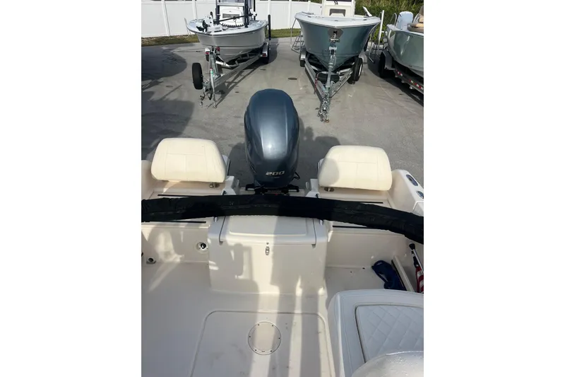Slide: The Image of 2018 Grady-White Freedom 215 boat with outboard motor, parked on a trailer. - 13