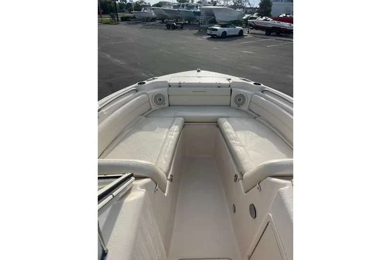 Slide: The Image of 2018 Grady-White Freedom 215 boat interior with cushioned seating and speakers. - 4