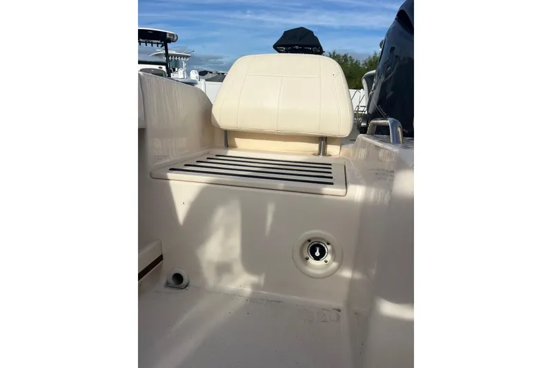 Slide: The Image of 2018 Grady-White Freedom 215 boat seat and deck detail under clear sky. - 9