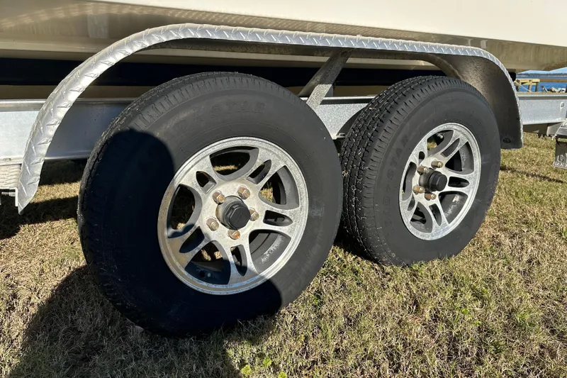 Slide: The Image of Trailer wheels of a 2020 Bay Rider 239 Bay boat on grass. - 11