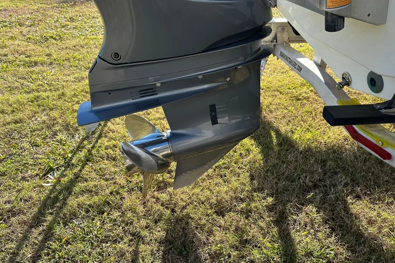 Slide: The Image of 2020 Bay Rider 239 Bay boat motor and propeller on grassy ground. - 13