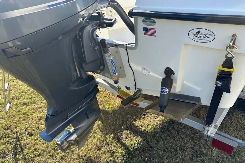 Slide: The Image of 2020 Bay Rider 239 Bay boat engine and transom detail on grass. - 14