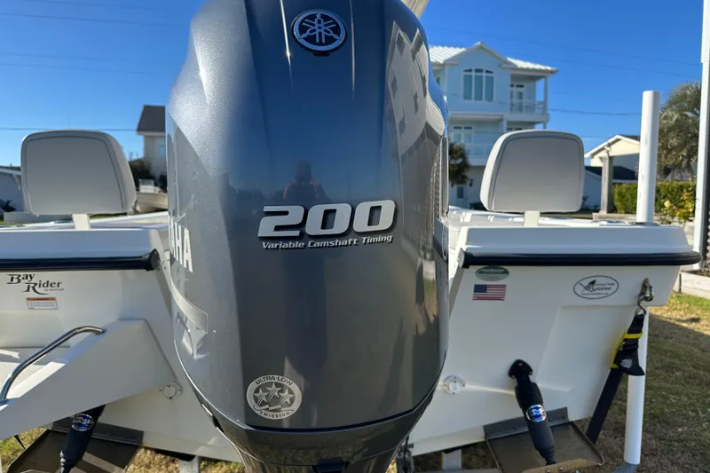 Slide: The Image of 2020 Bay Rider 239 Bay boat with Yamaha 200 engine, parked outdoors. - 16