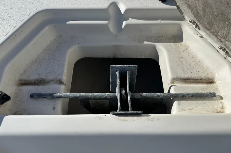 Slide: The Image of Anchor compartment of 2020 Bay Rider 239 Bay boat, showing metal anchor. - 18