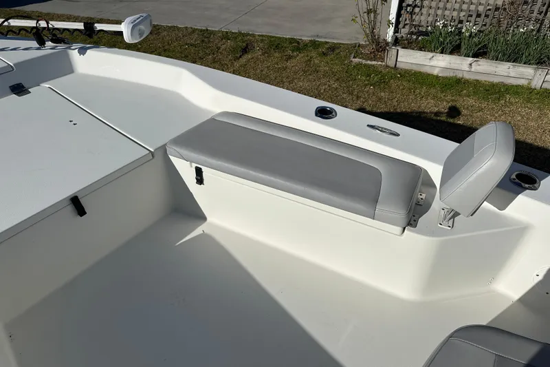 Slide: The Image of 2020 Bay Rider 239 Bay boat interior with gray seating and storage compartment. - 20