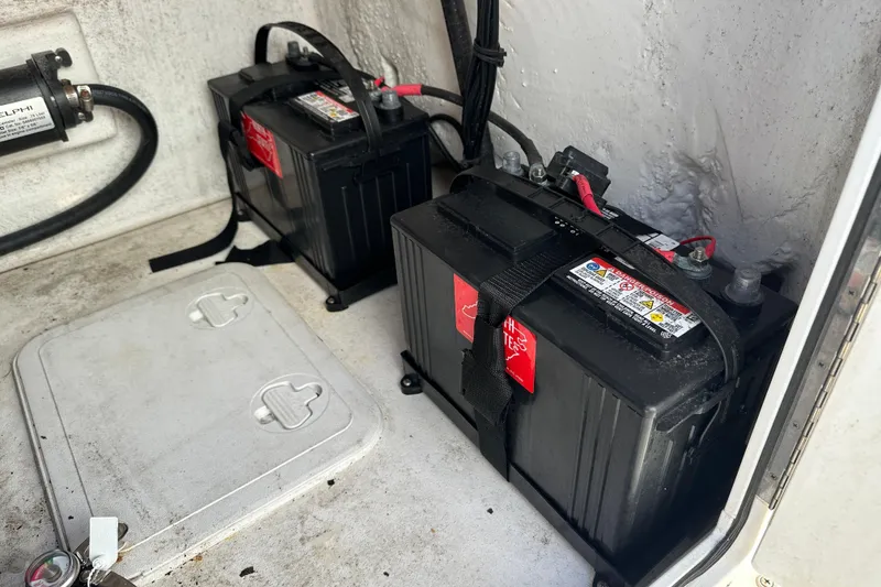 Slide: The Image of Batteries in a 2020 Bay Rider 239 Bay boat compartment, secured with straps. - 31