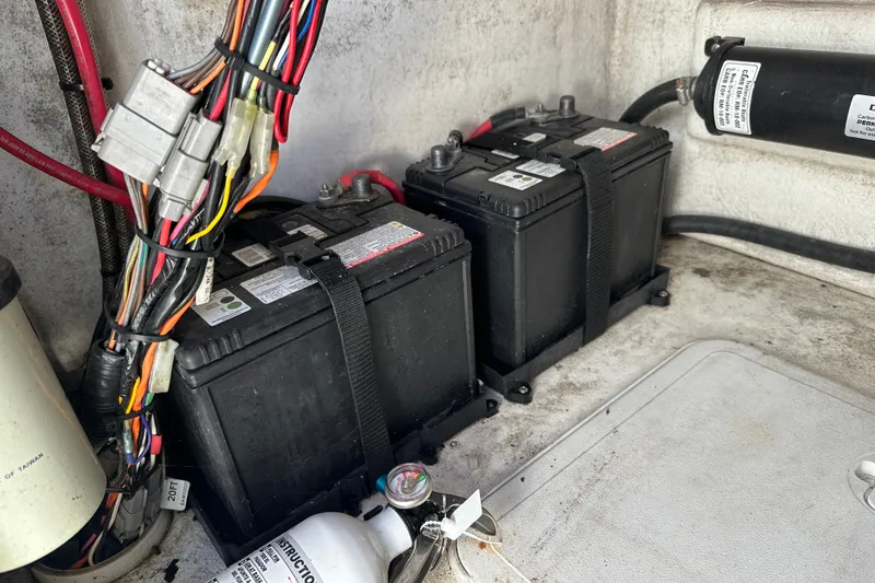 Slide: The Image of Battery compartment of 2020 Bay Rider 239 Bay boat with wiring and fire extinguisher. - 32