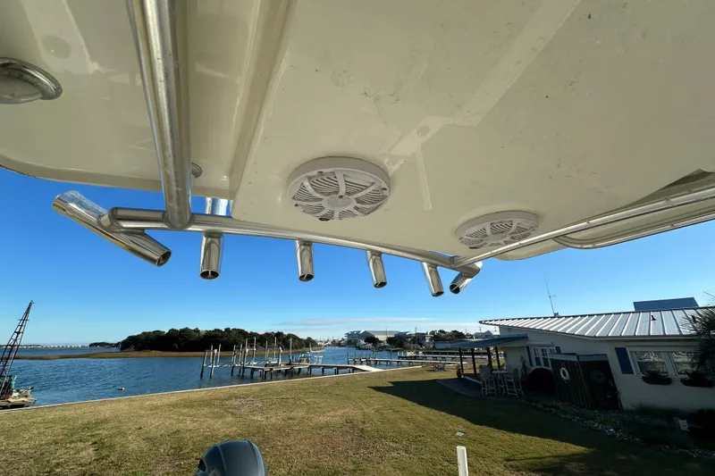 Slide: The Image of 2020 Bay Rider 239 Bay boat with rod holders and speakers, overlooking a scenic waterfront. - 36