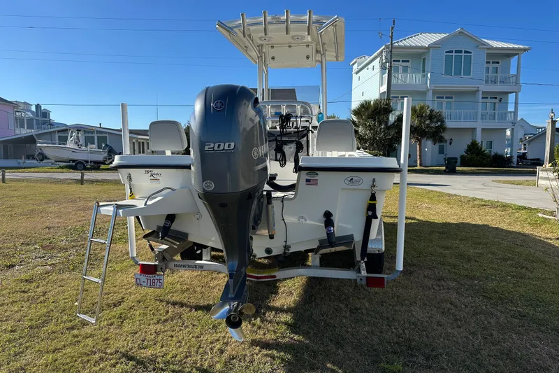 Slide: The Image of 2020 Bay Rider 239 Bay boat with Yamaha 200 engine, parked on grass. - 4