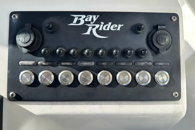 Slide: The Image of Control panel of 2020 Bay Rider 239 Bay boat with switches and 12V outlets. - 42