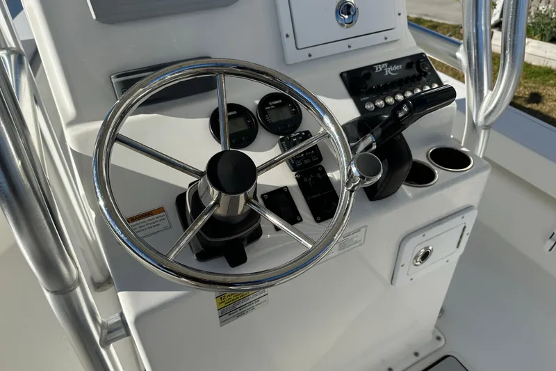 Slide: The Image of 2020 Bay Rider 239 Bay boat console with steering wheel and controls. - 43