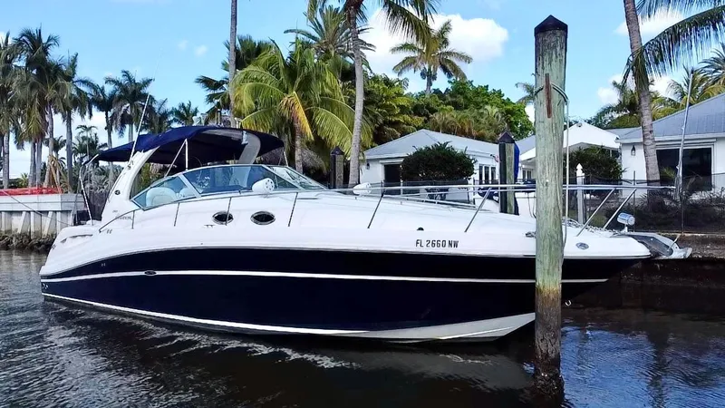 The Image of 2008 Sea Ray 420 Sundancer yacht docked near palm trees and waterfront homes. - 0