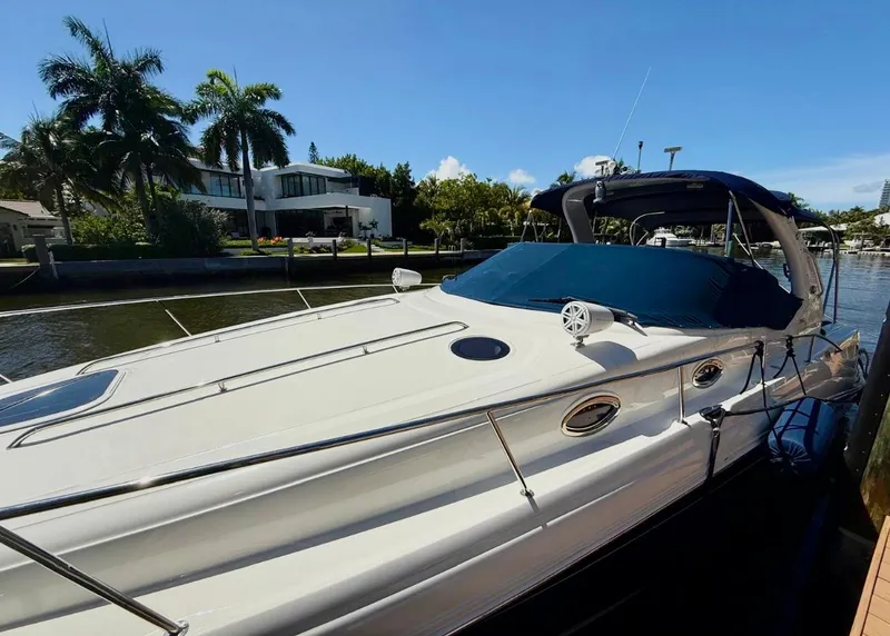 Slide: The Image of 2008 Sea Ray 340 Sundancer yacht docked by waterfront home, sunny day. - 1