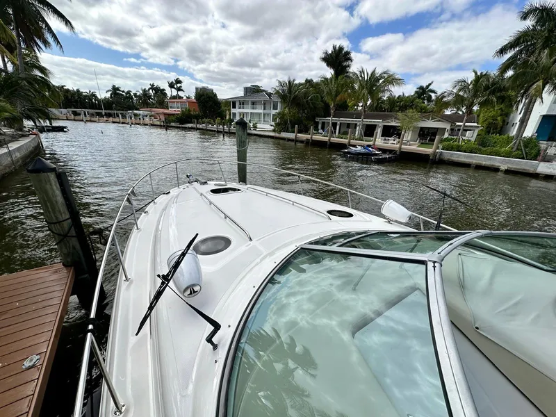 Slide: The Image of 2008 Sea Ray 340 Sundancer docked by a scenic waterfront with palm trees. - 20