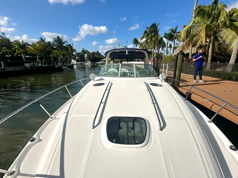 Slide: The Image of 2008 Sea Ray 420 Sundancer yacht docked, surrounded by palm trees and clear blue sky. - 21