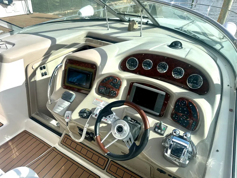 Slide: The Image of Cockpit of 2008 Sea Ray 420 Sundancer with modern navigation instruments and wood accents. - 27