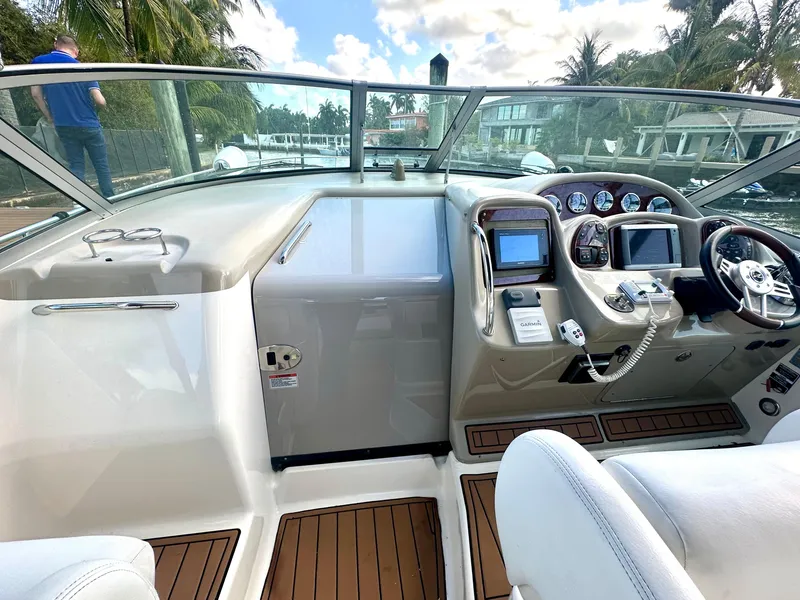 Slide: The Image of Cockpit of 2008 Sea Ray 420 Sundancer with modern controls and wood accents. - 48