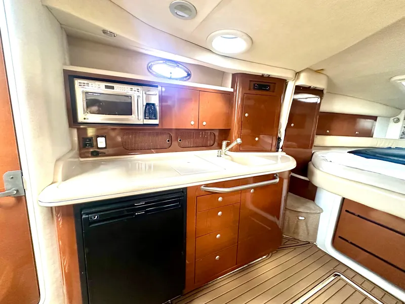 Slide: The Image of Interior of 2008 Sea Ray 340 Sundancer yacht with kitchenette and wood cabinetry. - 60