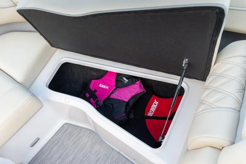 Slide: The Image of Manufacturer Provided Image: Regal LX6 2022 boat storage compartment with life jackets. - 17