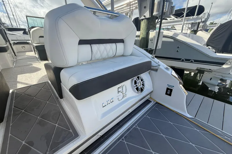Slide: The Image of 2022 Regal LX6 boat interior with white seating and speaker detail. - 18
