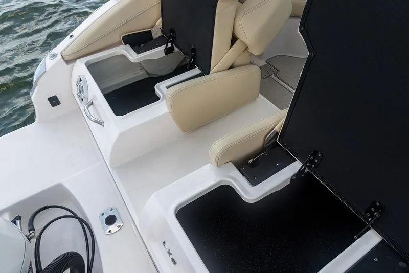 Slide: The Image of Manufacturer Provided Image: 2022 Regal LX6 boat with open storage compartments and beige seating. - 19