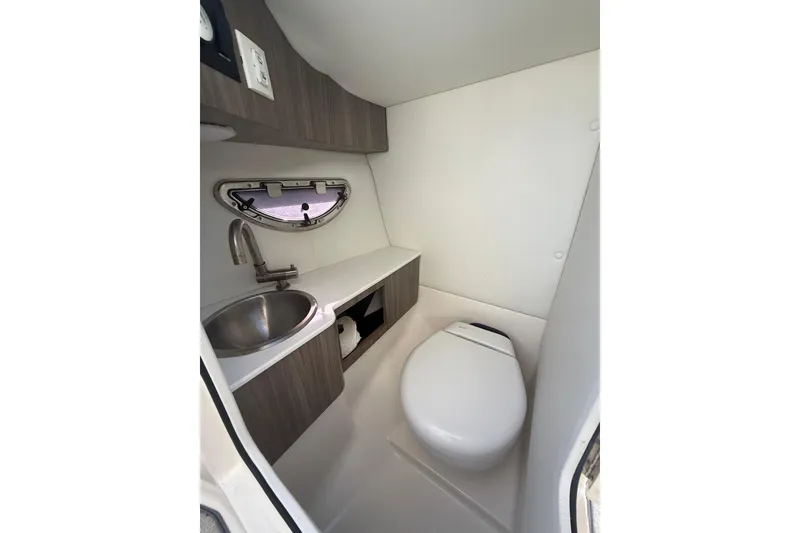 Slide: The Image of 2022 Regal LX6 boat interior bathroom with sink and toilet. - 20