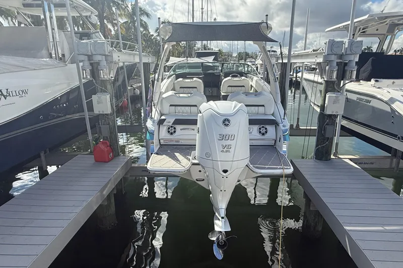 Slide: The Image of 2022 Regal LX6 boat docked at marina with Yamaha 300 V6 engine. - 21