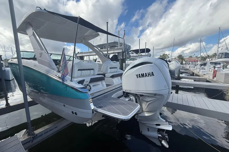 Slide: The Image of 2022 Regal LX6 boat with Yamaha engine docked at marina under cloudy sky. - 22