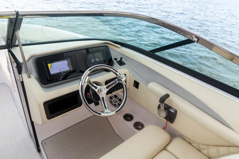 Slide: The Image of Manufacturer Provided Image: 2022 Regal LX6 boat cockpit with steering wheel and navigation system. - 8