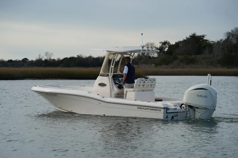 Slide: The Image of 2026 Grady-White 251 Coastal Explorer boat on calm water, side view. - 10
