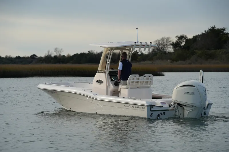 Slide: The Image of 2026 Grady-White 251 Coastal Explorer boat cruising on calm waters. - 11