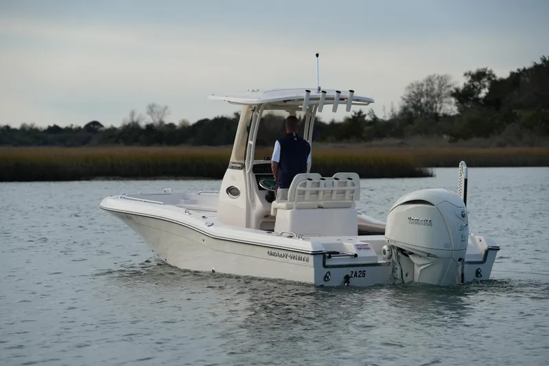 Slide: The Image of 2026 Grady-White 251 Coastal Explorer boat cruising on calm water. - 12