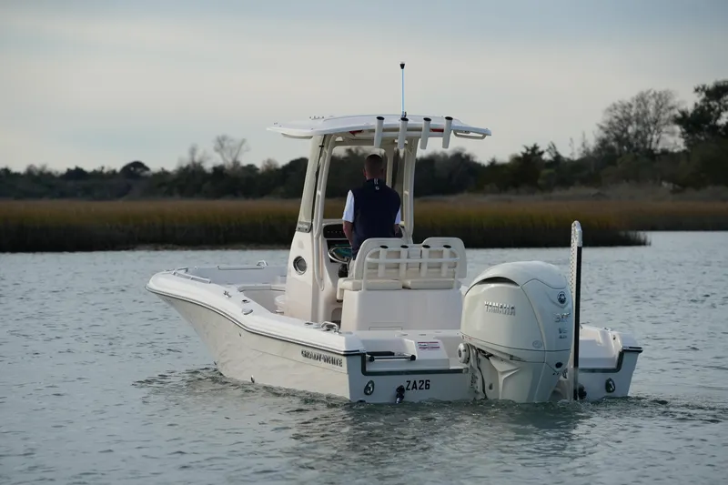 Slide: The Image of 2026 Grady-White 251 Coastal Explorer boat on calm water, rear view. - 13