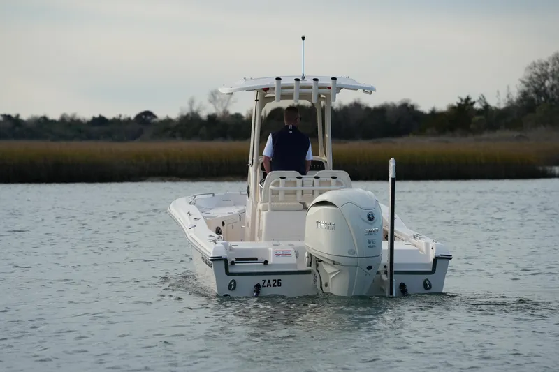 Slide: The Image of 2026 Grady-White 251 Coastal Explorer boat on calm water, rear view. - 14