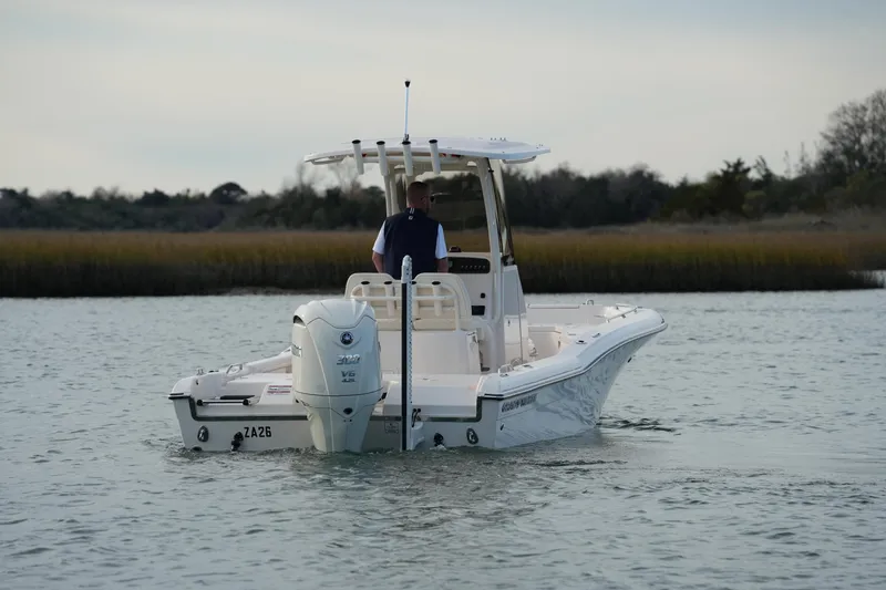 Slide: The Image of 2026 Grady-White 251 Coastal Explorer boat cruising on calm waters. - 17