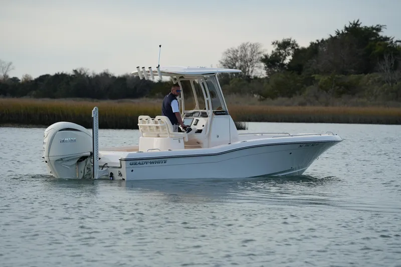 Slide: The Image of 2026 Grady-White 251 Coastal Explorer boat cruising on calm water. - 18