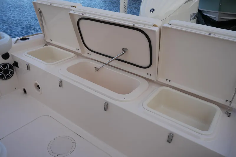 Slide: The Image of 2026 Grady-White 251 Coastal Explorer boat storage compartments open on deck. - 20