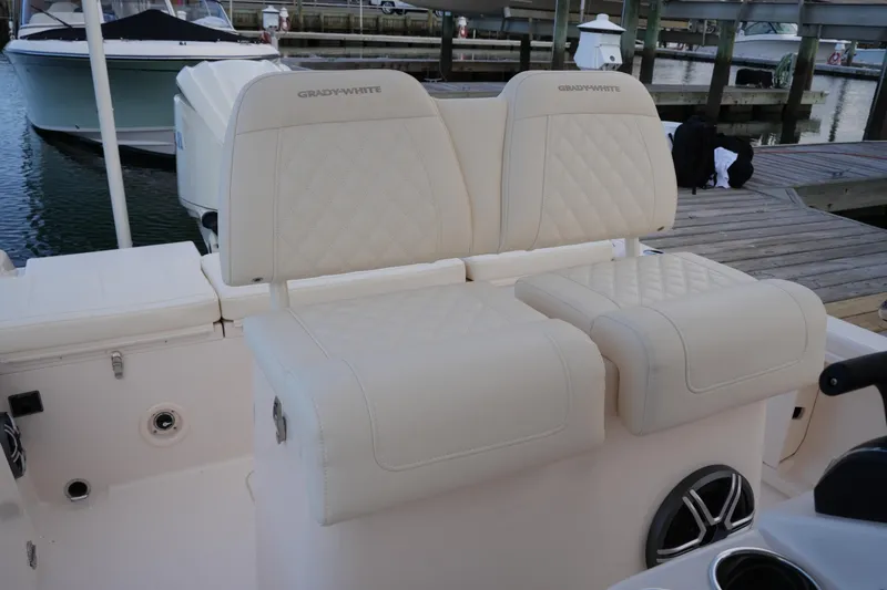 Slide: The Image of 2026 Grady-White 251 Coastal Explorer boat seats with quilted design at dock. - 24