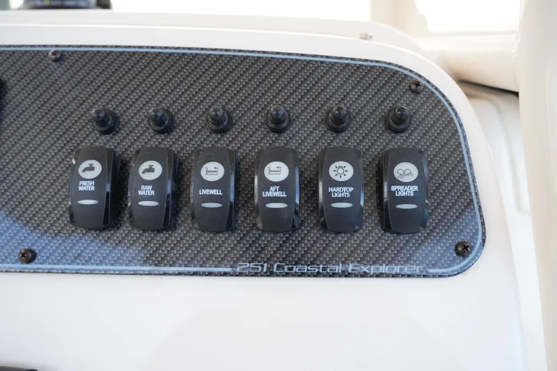 Slide: The Image of Control panel of 2026 Grady-White 251 Coastal Explorer boat with labeled switches. - 26